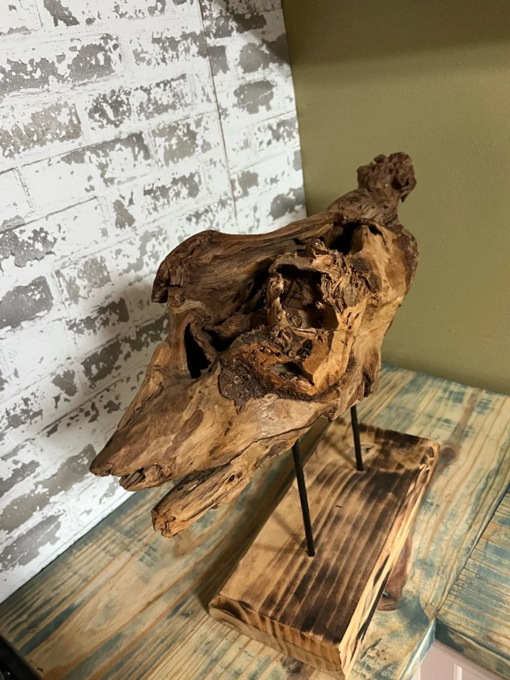Natural weathered wood teak root rustic tabletop art piece supported by metal